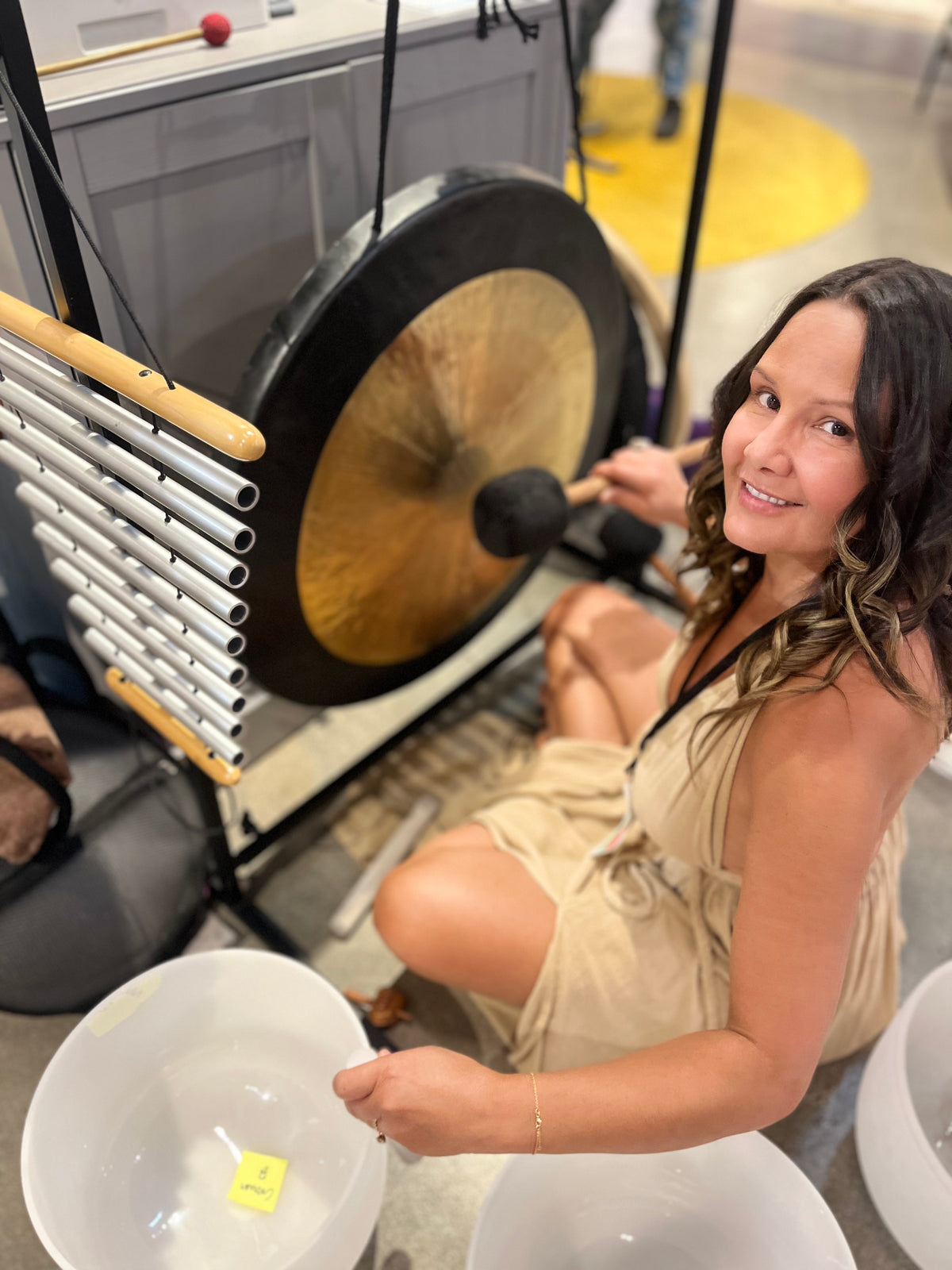 Melissa of House of Sueño playing the gong and crystal bowls at a 432Hz sound bath in Los Angeles