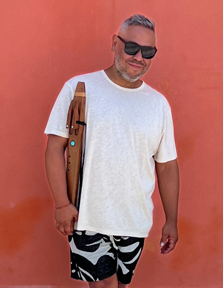 Nicholas Vidal holding a 432Hz Mayan drone flute in Los Angeles